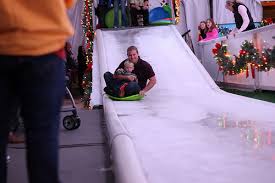 christmas fun starts with a trip on the ice slide during an original orlando tours visit to light up ucf