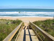 this walkway leads to the sun and sand of one of florida's most beautiful beaches experienced during an original orlando tours visit to the cape canaveral beach