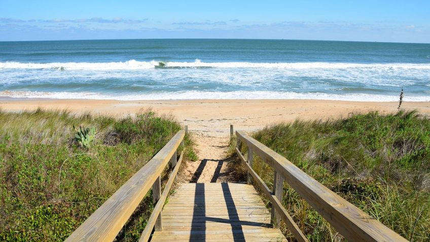 this walkway leads to the sun and sand of one of florida's most beautiful beaches experienced during an original orlando tours visit to the cape canaveral beach